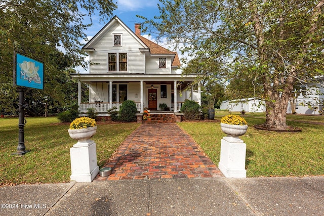 505 Broad St, Oriental, NC 28571 - view of front facade featuring a porch, a chimney, and a front lawn