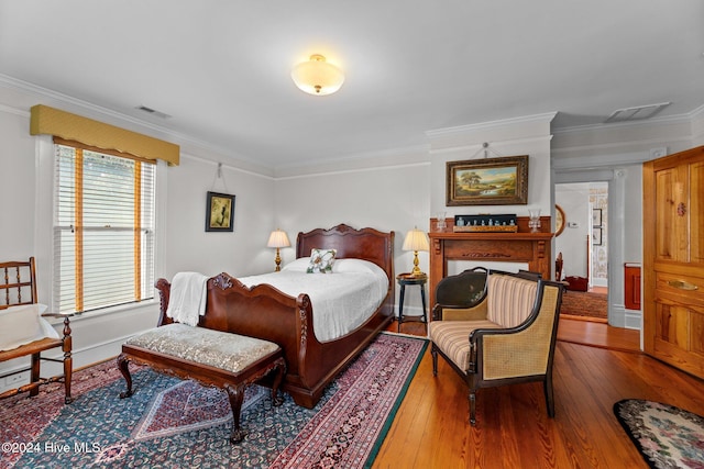 bedroom featuring hardwood / wood-style floors and ornamental molding