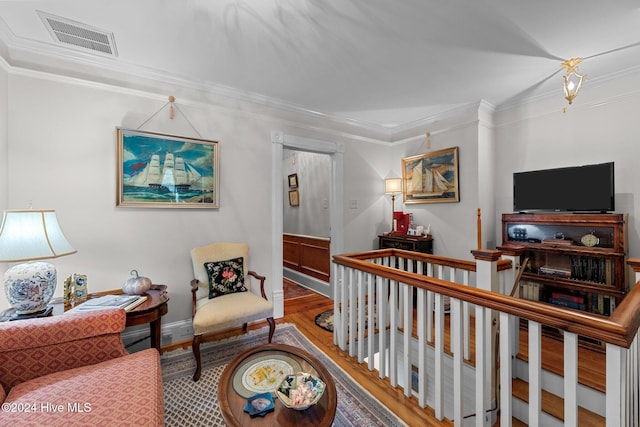 interior space featuring wood-type flooring and ornamental molding