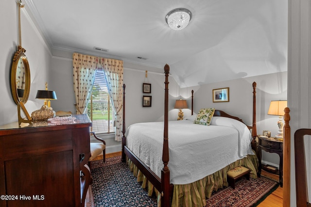 bedroom featuring crown molding and hardwood / wood-style flooring