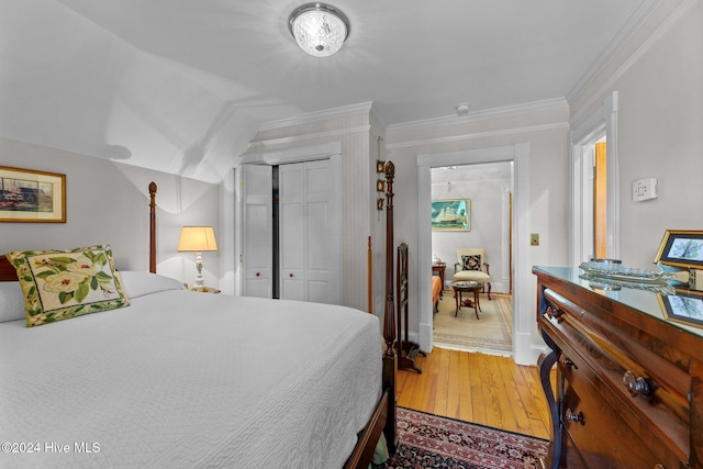 bedroom featuring hardwood / wood-style floors, a closet, and crown molding