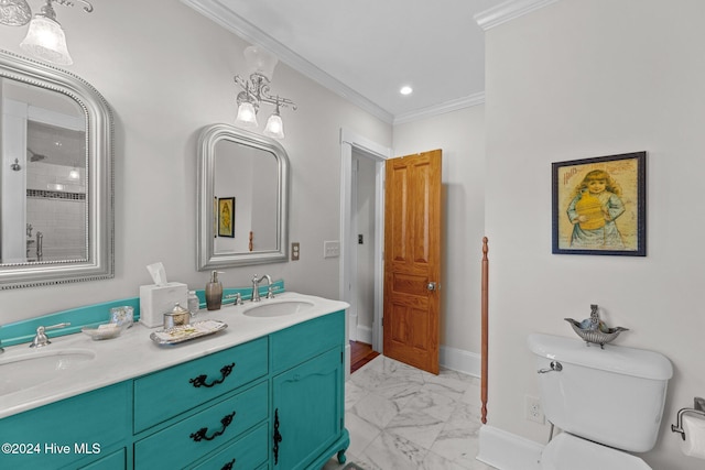 bathroom with toilet, vanity, and ornamental molding