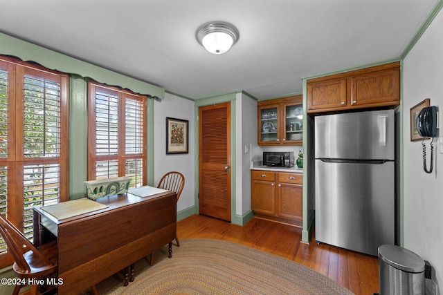 kitchen featuring dark hardwood / wood-style flooring, stainless steel refrigerator, and plenty of natural light