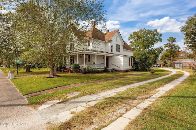 view of home's exterior with a lawn and covered porch