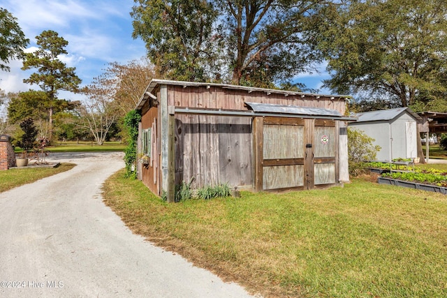 view of outbuilding with a yard