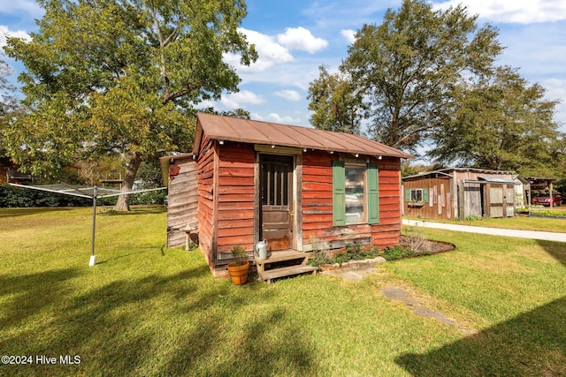 view of outbuilding with a yard