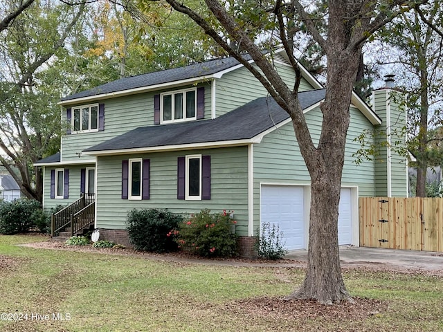 view of front facade featuring a front yard and a garage