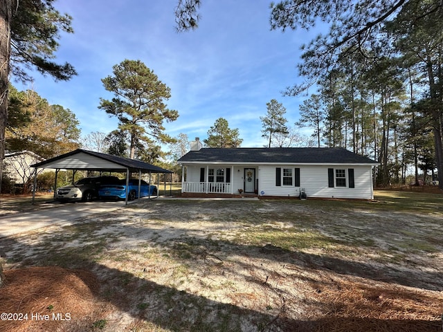 view of front facade with covered porch, a front lawn, and a carport