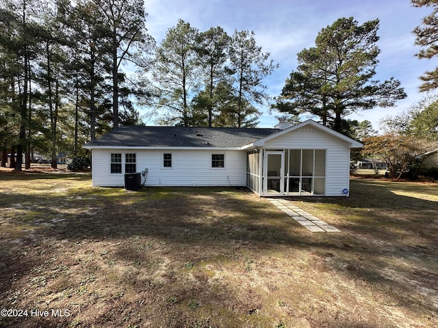 back of property featuring a lawn and a sunroom