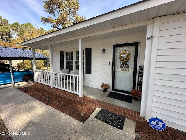 view of exterior entry with covered porch