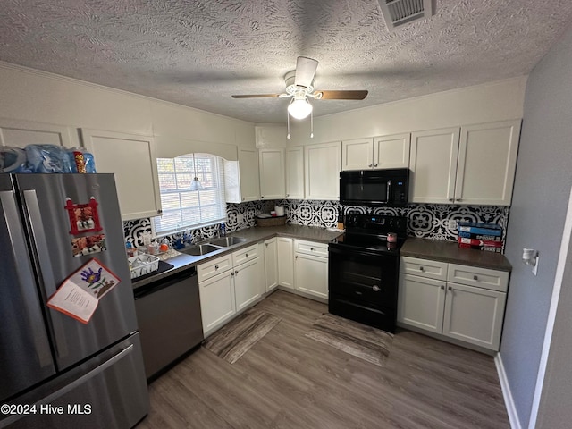 kitchen with ceiling fan, dark wood-type flooring, decorative backsplash, white cabinets, and black appliances