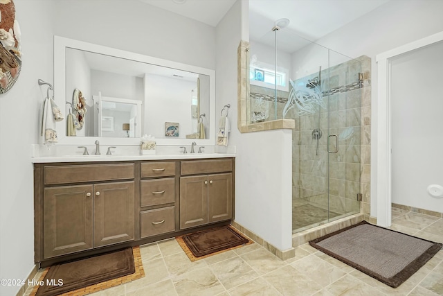 bathroom featuring a shower with door and vanity