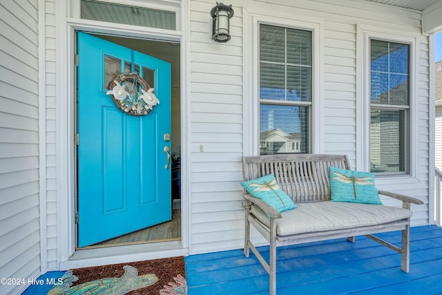 view of exterior entry featuring a porch