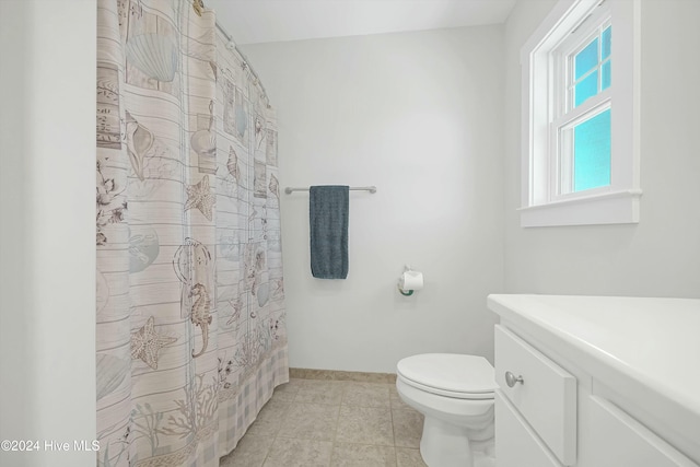 bathroom with tile patterned floors, vanity, and toilet