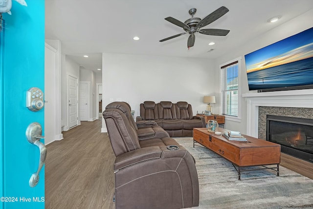 living room with hardwood / wood-style floors and ceiling fan