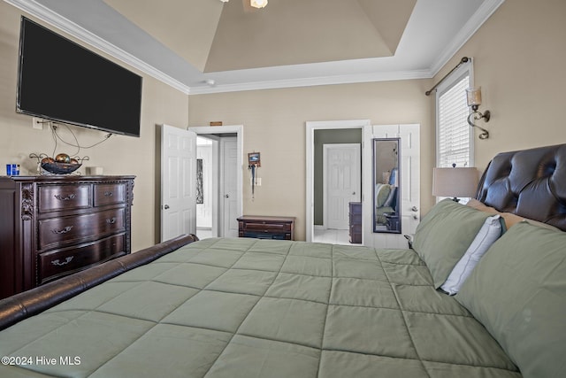 bedroom featuring lofted ceiling and crown molding