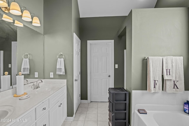 bathroom with tile patterned flooring, vanity, a tub, and vaulted ceiling