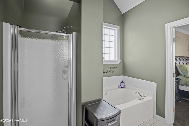 bathroom featuring tile patterned floors, vaulted ceiling, and shower with separate bathtub