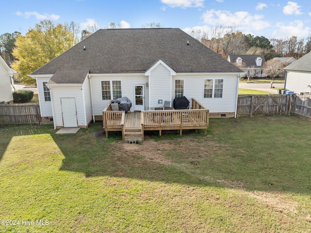 back of property with a lawn and a wooden deck