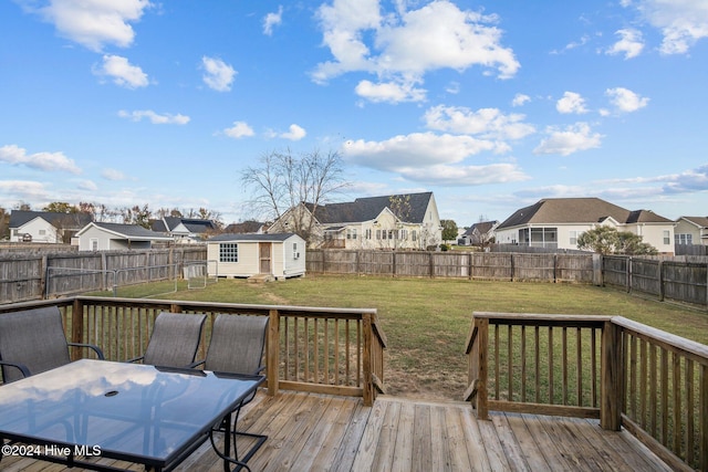 wooden deck with a shed and a yard