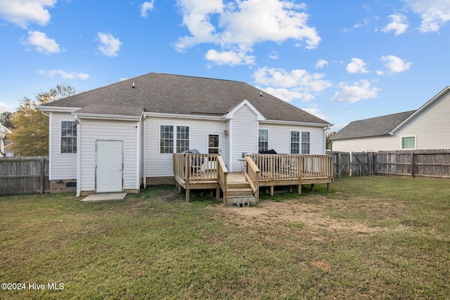 back of house with a deck and a lawn