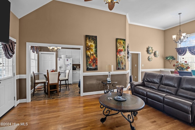 living room featuring hardwood / wood-style flooring, plenty of natural light, and crown molding