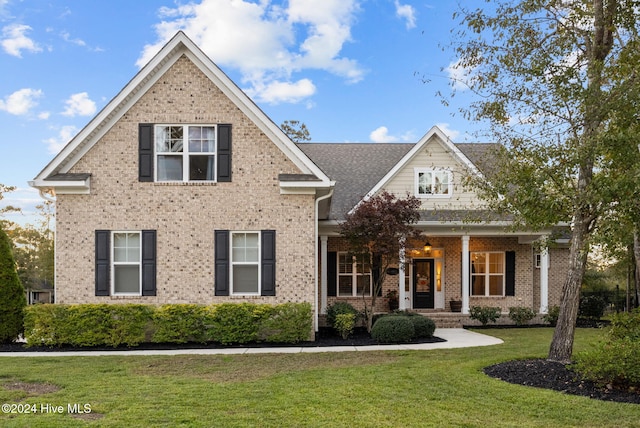 view of front of home featuring a front lawn and covered porch