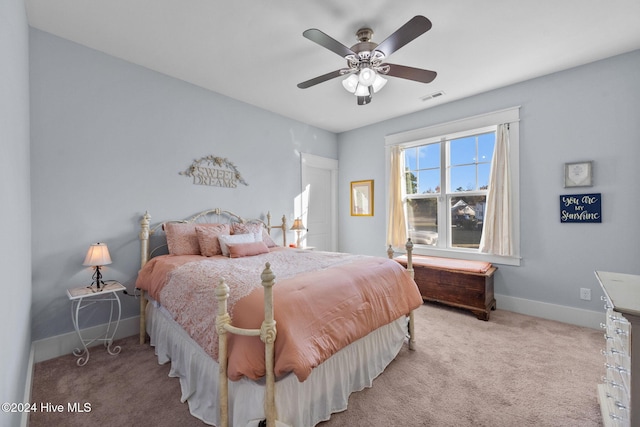 bedroom with ceiling fan and light colored carpet