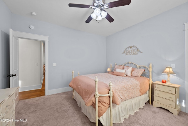 bedroom featuring light colored carpet and ceiling fan