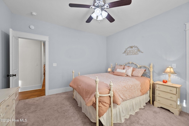 bedroom with carpet, a ceiling fan, and baseboards