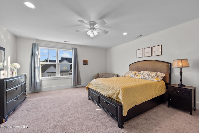 bedroom featuring visible vents, ceiling fan, baseboards, and light carpet