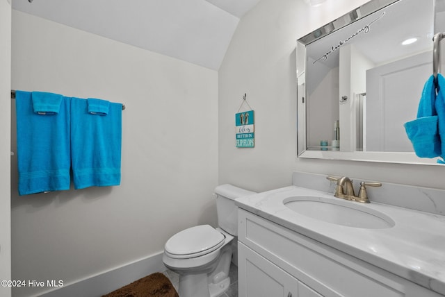 bathroom featuring toilet, vanity, and baseboards