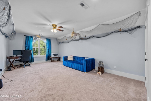 unfurnished office with carpet flooring, visible vents, ceiling fan, and baseboards