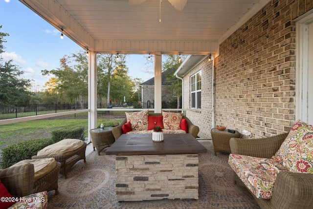 sunroom with ceiling fan and wood ceiling