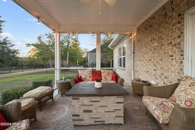 sunroom / solarium featuring ceiling fan and an outdoor hangout area