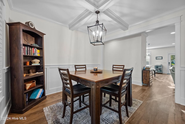 dining space featuring dark hardwood / wood-style flooring, coffered ceiling, crown molding, beam ceiling, and a chandelier