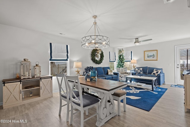 dining space with ceiling fan and light hardwood / wood-style floors