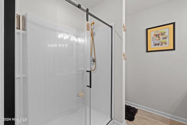 bathroom featuring hardwood / wood-style flooring and walk in shower