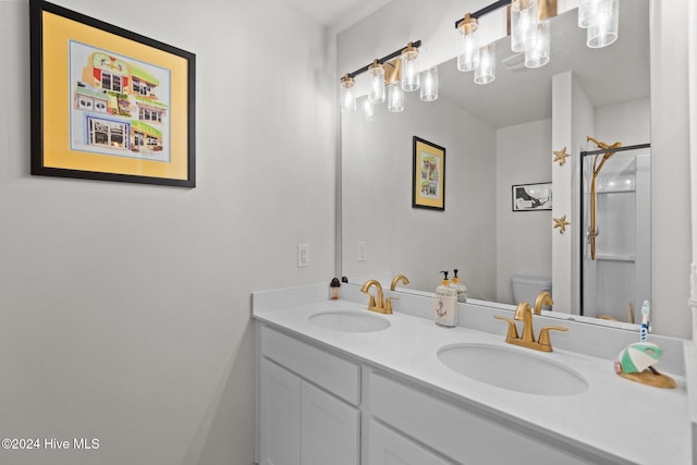 bathroom featuring vanity, toilet, and an enclosed shower