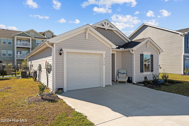 view of front of home with central AC and a garage