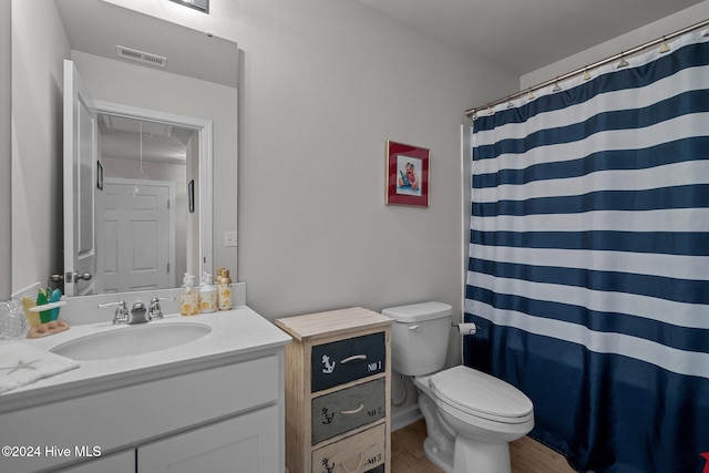 bathroom featuring vanity, curtained shower, toilet, and wood-type flooring