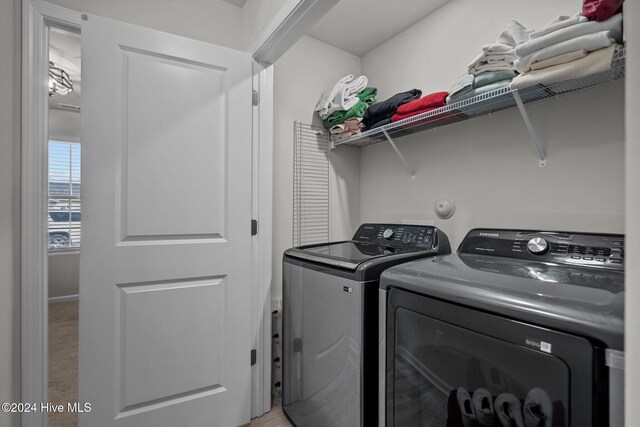 clothes washing area featuring independent washer and dryer