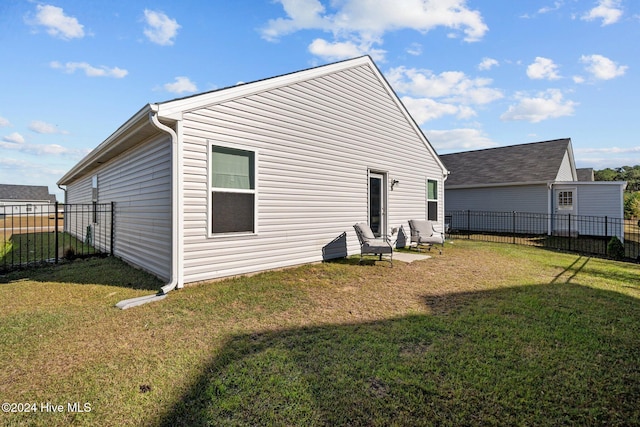 back of house featuring a lawn