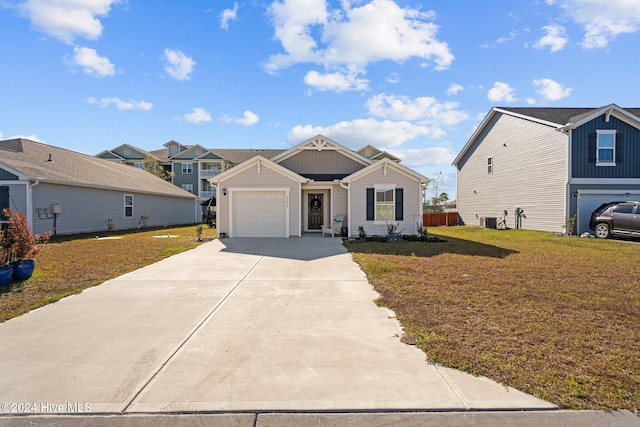 view of front of house with a front yard, a garage, and central air condition unit