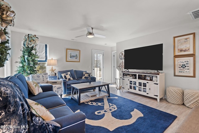 living room with light hardwood / wood-style flooring and ceiling fan