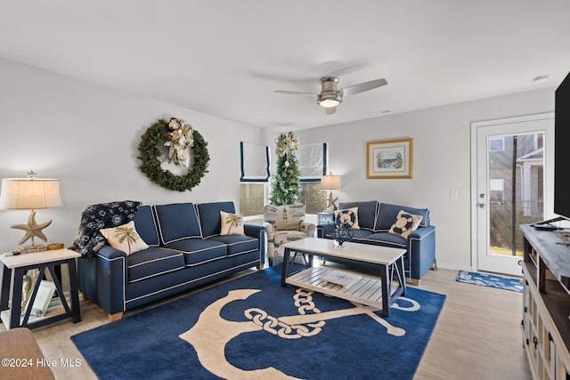 living room with ceiling fan and light hardwood / wood-style floors