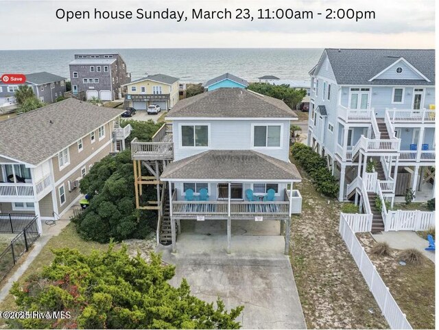 birds eye view of property featuring a water view and a beach view