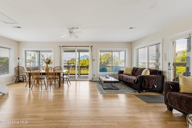 living room featuring ceiling fan and light hardwood / wood-style floors