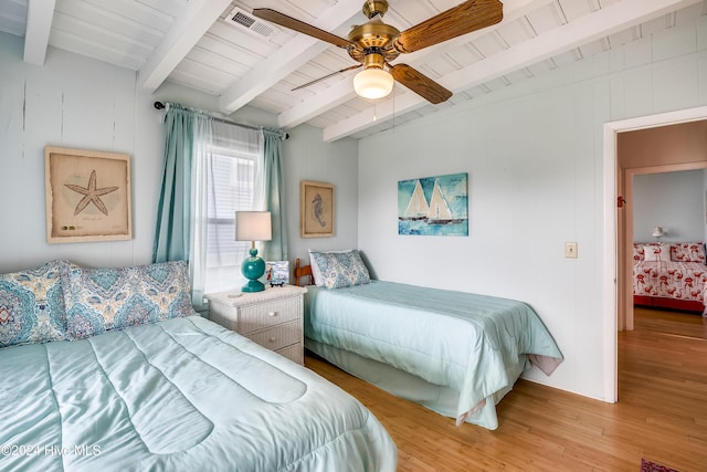 bedroom featuring ceiling fan, light hardwood / wood-style flooring, beamed ceiling, and wood ceiling