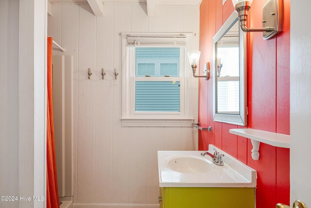 bedroom with access to exterior, wood-type flooring, multiple windows, and ceiling fan